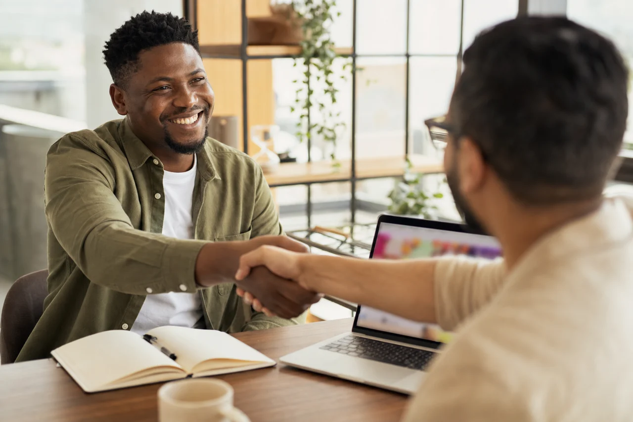 A South African business owner and a web designer discussing a project to choose the right option